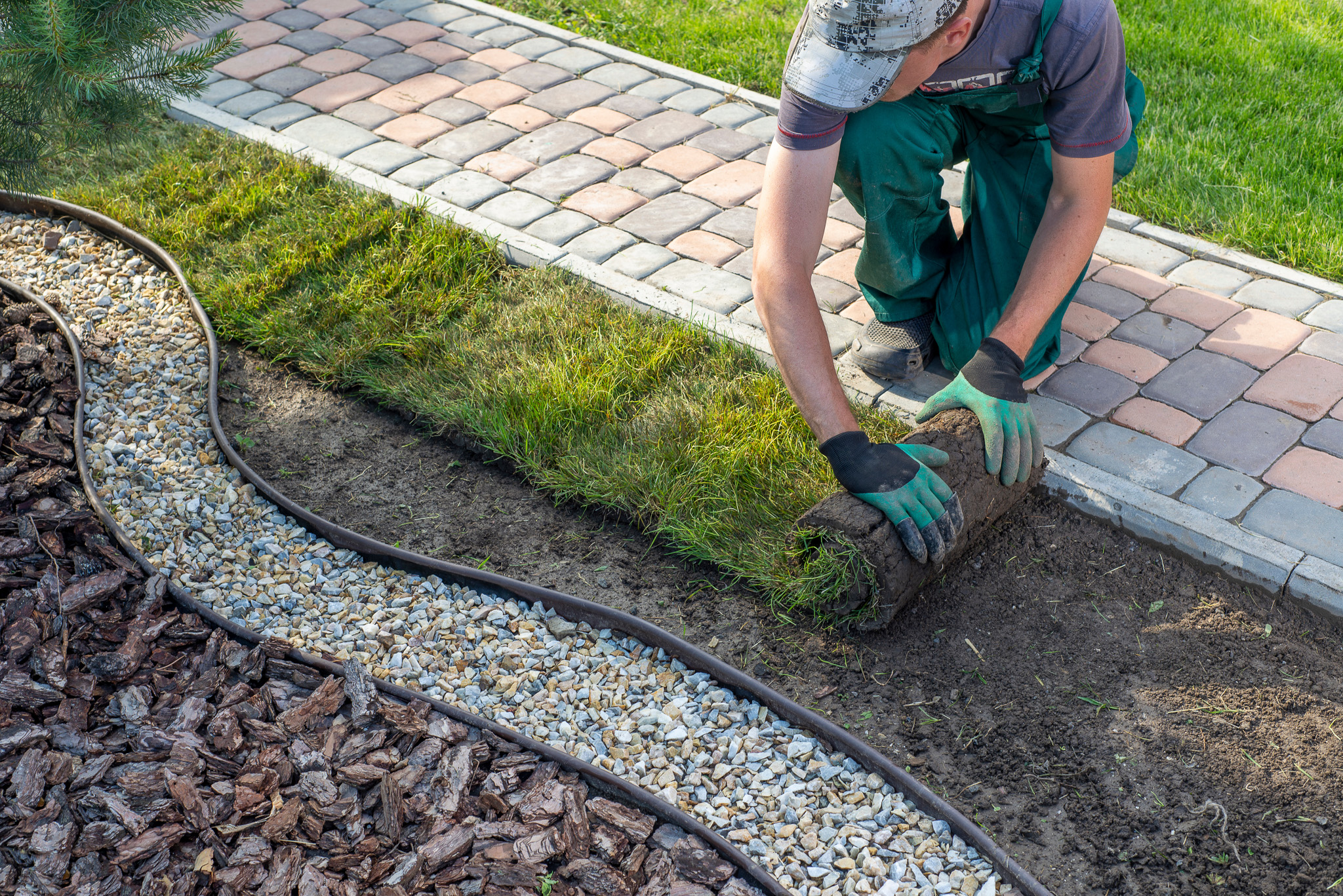 Landscape Gardener Laying Turf For New Lawn